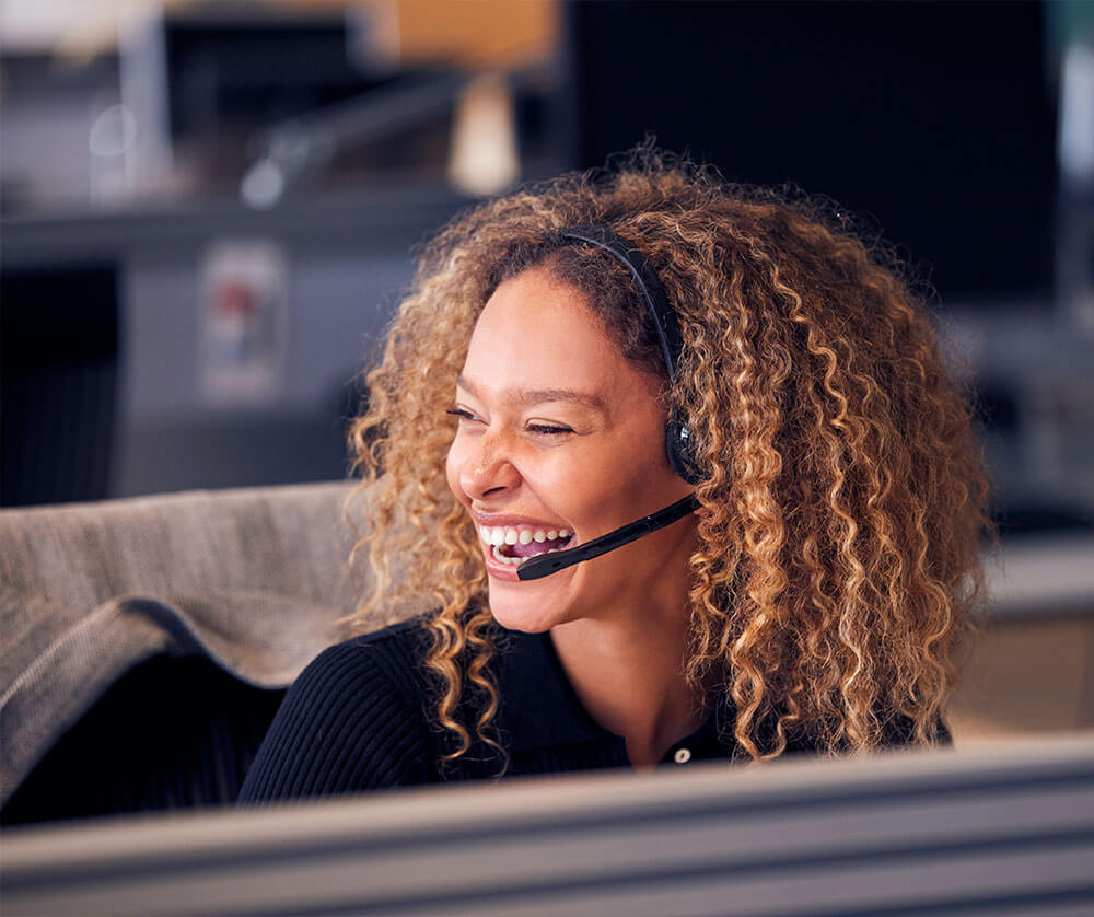 woman happy inside of a call center