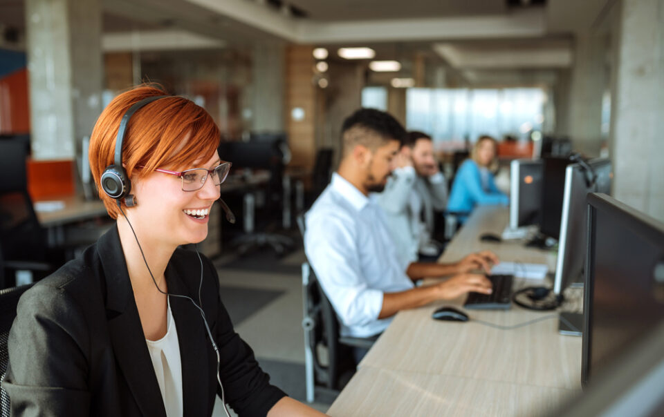 BDC agents working at thier desks with headphones on