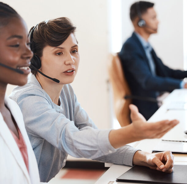 Black woman, manager and training in office in call center for customer service, headset and online faq. Female agent, headphones and staff help in telemarketing agency for consultation and crm coach