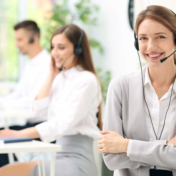 Young female receptionist with headset in office