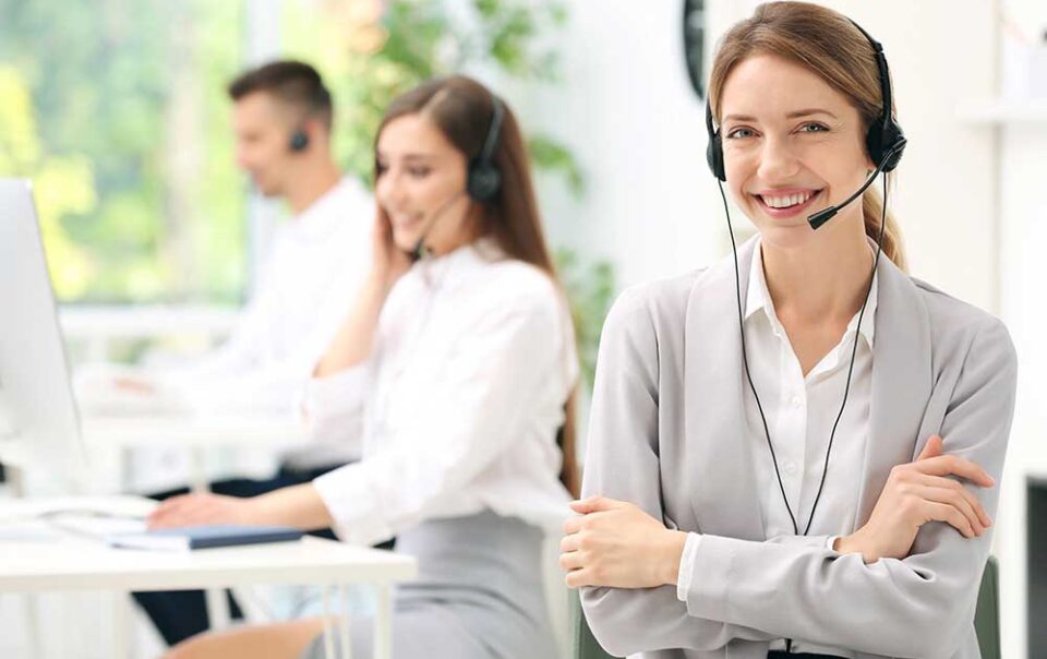 Young female receptionist with headset in office