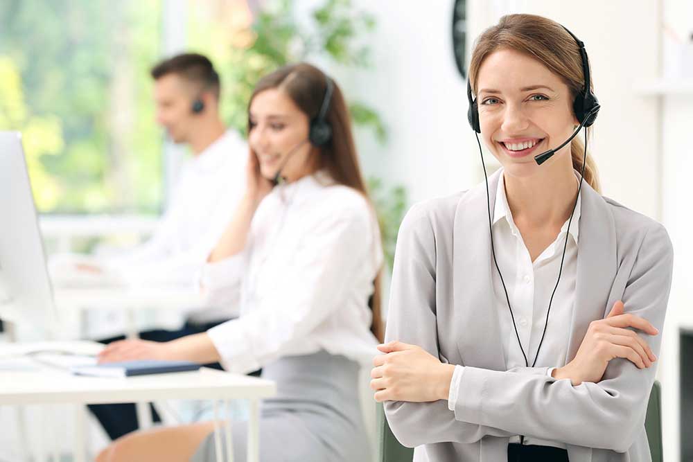 Young female receptionist with headset in office