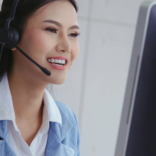 bdc agent female with headset on smiling at dashboard