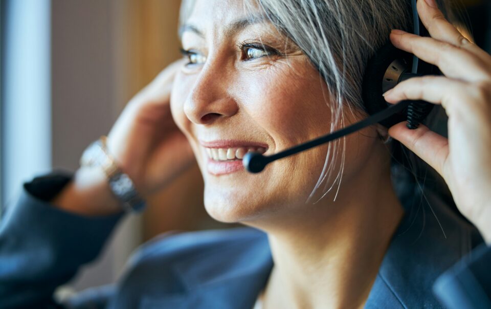 bdc agent with headset on smiling